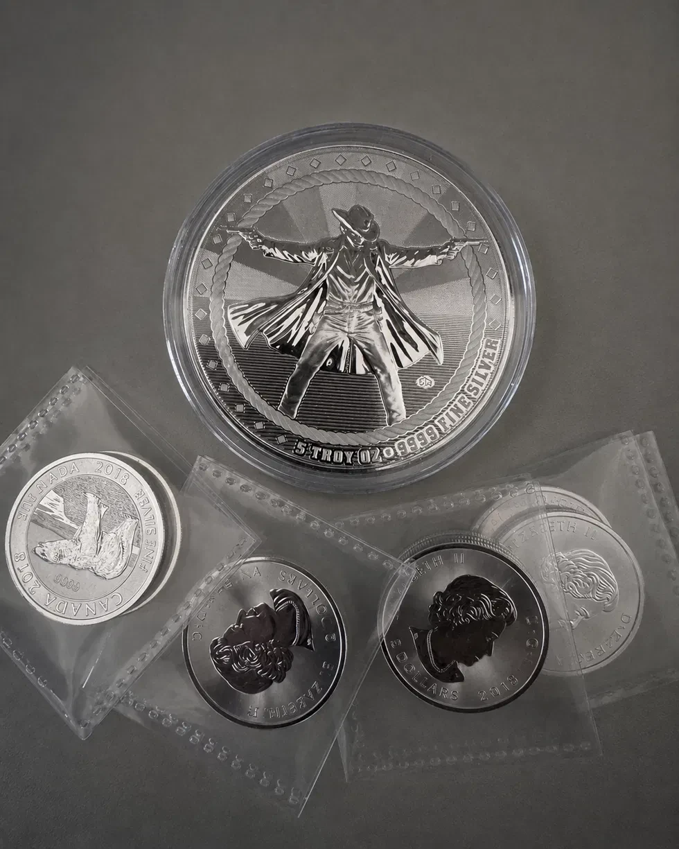 A silver coin stack including a 5 oz Gunslinger